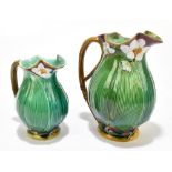MINTON; two 19th century majolica jugs, each moulded with white flowers and green leaves against