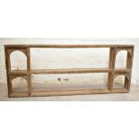 A rustic limed oak hanging plate rack, with arched side sections, length 165cm, height 68cm.