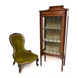 An early 20th century mahogany bow front display cabinet, the leaded glazed door enclosing two