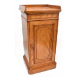 GILLOWS; a Victorian satin walnut and inlaid bedside cabinet with three-quarter raised gallery above