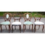 GILLOWS; a pair of Victorian carved rosewood side chairs, with scroll carved backs and floral