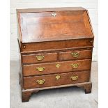 A George III oak bureau with fall-front enclosing a fitted interior with eight drawers and four