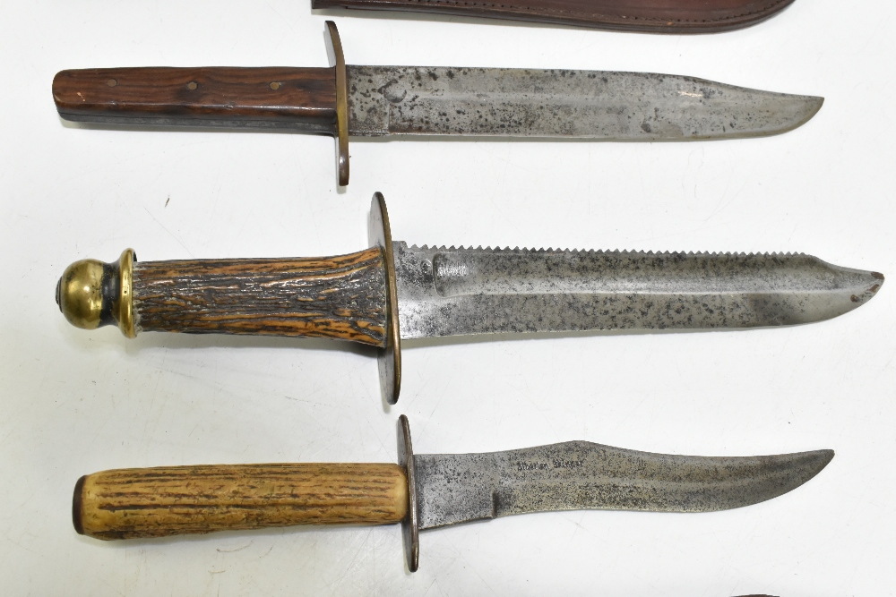 Four knives/daggers, the largest a sawback example with stamped marks to blade base, the brass guard - Image 4 of 11