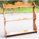 A Victorian mahogany set of hanging shelves, the three graduated shelves with serpentine side