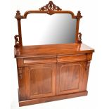 A Victorian mahogany mirror back chiffonier with two drawers above twin cupboard doors enclosing