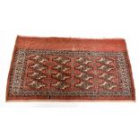 A Bokhara rug worked with sixteen guls against a red ground, 133 x 75cm.Additional InformationFading
