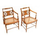 A pair of Edwardian stained beech and painted elbow chairs with turned top rail above down swept