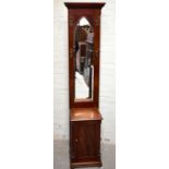 A Victorian Gothic Revival mahogany hall stand of narrow proportions, with shaped bevelled mirror