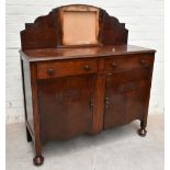 A 1930s oak mirror back sideboard, with fan shaped mirror above two drawers and two cupboard