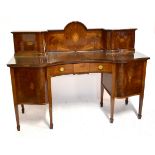 A late 19th century inlaid mahogany serpentine fronted sideboard, the back section with two cupboard