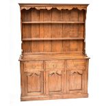 An 18th century style oak dresser, the back with two open shelves over three short drawers and three