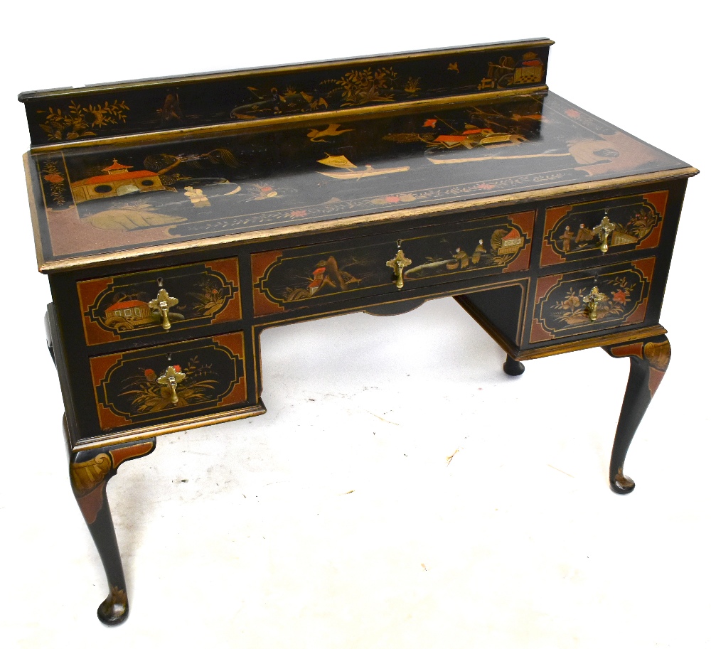 A early 20th century black lacquered kneehole writing table with gallery back, with chinoiserie