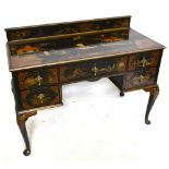 A early 20th century black lacquered kneehole writing table with gallery back, with chinoiserie