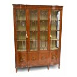 A fine late Victorian satinwood painted display cabinet with moulded cornice, serpentine side glazed