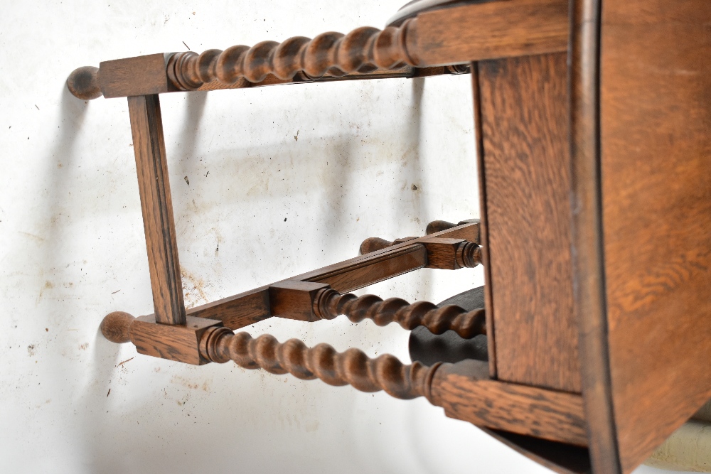 A 1920s oak dropleaf gateleg dining table, raised on barleytwist supports, height 73cm, length 88cm. - Image 3 of 4