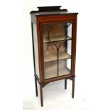 An Edwardian inlaid mahogany display cabinet with astragal glazed door enclosing three shelves, on