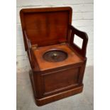 A Victorian mahogany box commode, the hinged top enclosing two folding arms and a circular lid above