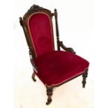 A Victorian carved rosewood lady's salon chair with burgundy dreylon upholstered back and seat on