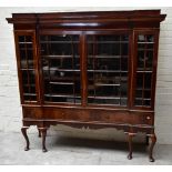 An early 20th century inlaid mahogany inverted breakfront display cabinet, the four astragal