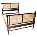 An Edwardian mahogany double bedstead with king head and footboard, on square tapering supports.