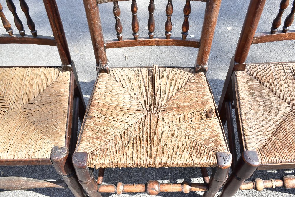 A harlequin set of six 19th century and later rush seated spindle back dining chairs, raised on - Image 2 of 4