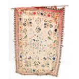A South East Asian tapestry wall hanging with embroidered decoration of flora, fauna, script and