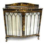 An early 20th century black lacquered serpentine fronted display cabinet with chinoiserie