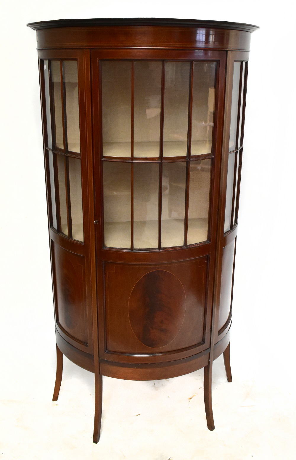 An Edwardian mahogany and boxwood inlaid bowfront display cabinet, with curved door enclosing two