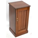 An Edwardian walnut pot cupboard, the single panel door enclosing a fixed shelf, raised on plinth