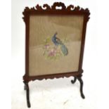 An early 20th century walnut fret frame fire screen on cabriole legs, height 74cm, width 51cm.