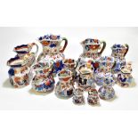 Thirteen assorted 19th century and later ironstone jugs, each decorated in the Imari palette, height