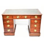 A late 19th century mahogany twin pedestal knee-hole desk, with green leather inset top above an