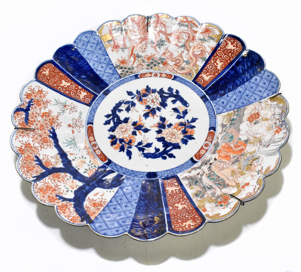 A large late 19th century Japanese Imari charger, of circular form with panelled detail depicting