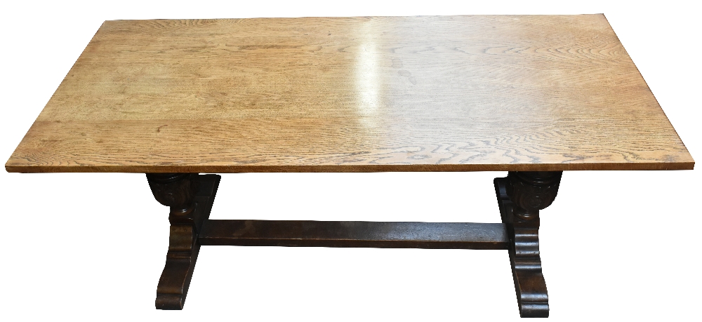 An early 20th century oak refectory type table with rectangular top on two carved baluster