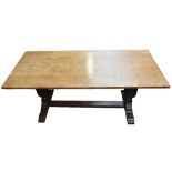 An early 20th century oak refectory type table with rectangular top on two carved baluster