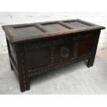 An 18th century carved oak coffer of small proportions, the front with carved and panelled detail,