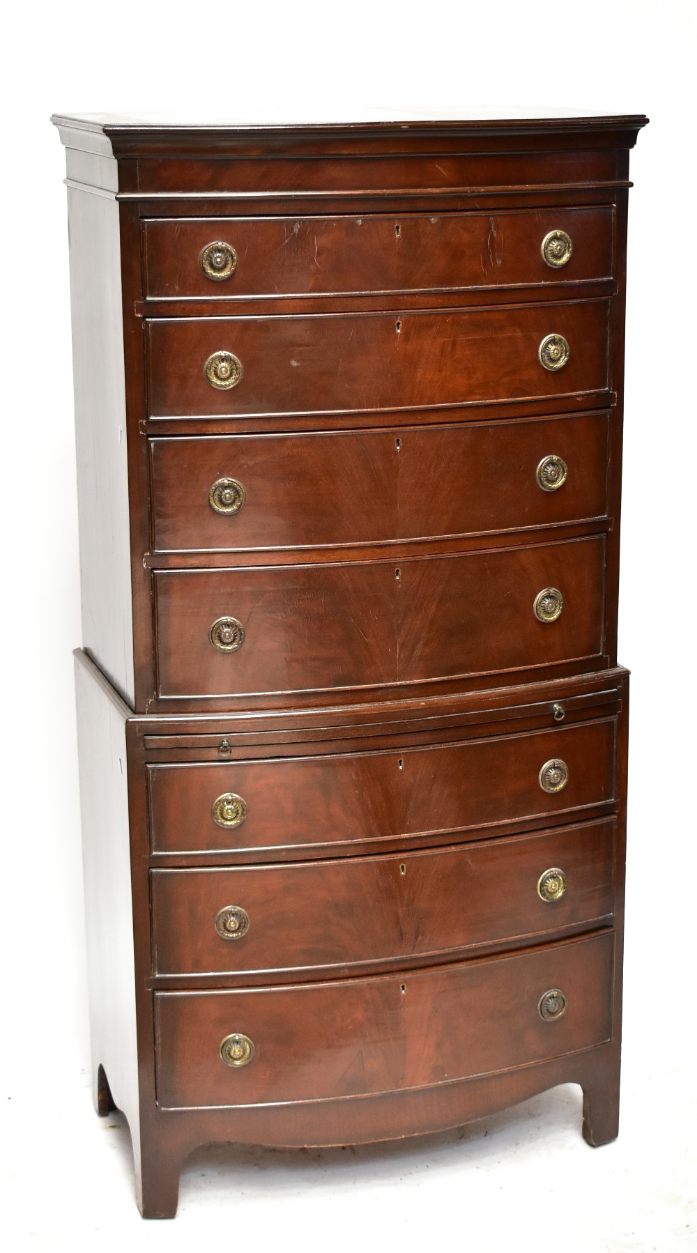 A reproduction mahogany bowfront chest on chest, the upper section with four drawers above brush