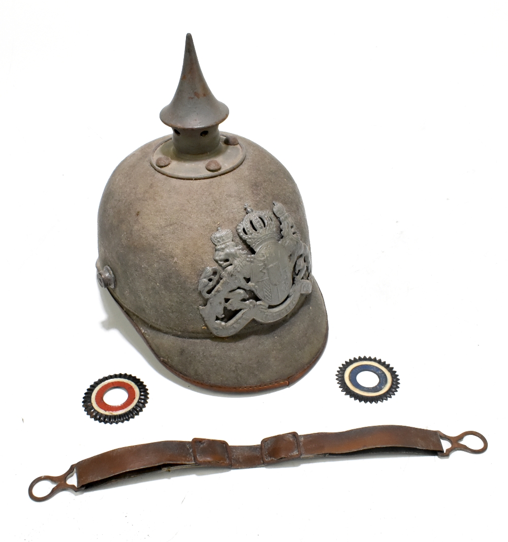 A late 19th/early 20th century German Imperial pickelhaube in green felt with two rosettes, chin