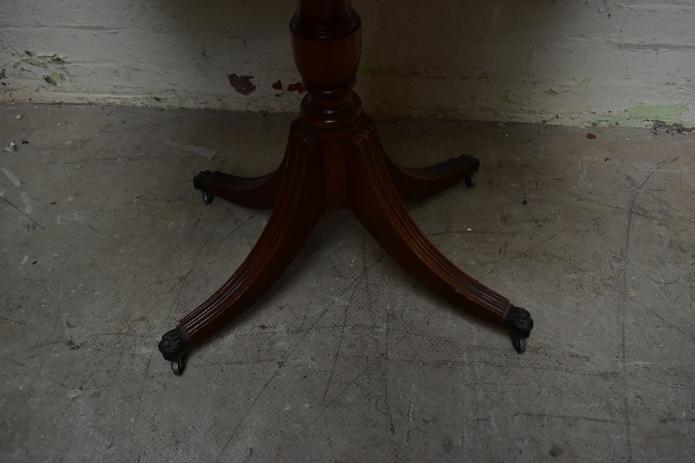 A reproduction mahogany veneered fold-over card table, raised on baluster from supports - Image 4 of 4