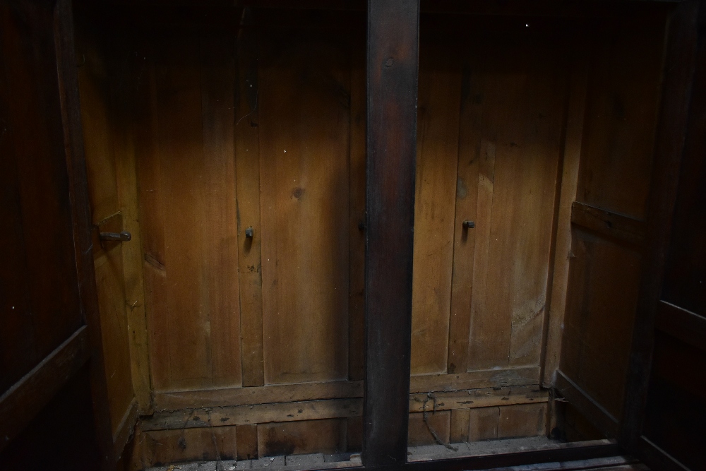 A 19th century oak cupboard on stand, the twin panelled doors an arrangement of hooks, above two - Image 4 of 4