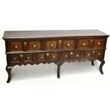 An 18th century oak dresser, the rectangular top with a moulded edge above three long drawers and