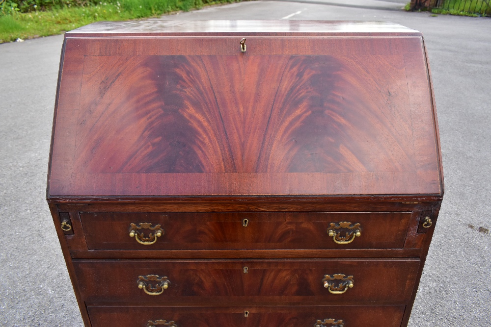 A reproduction mahogany veneered bureau, the fall front above four drawers, raised on bracket - Image 2 of 4