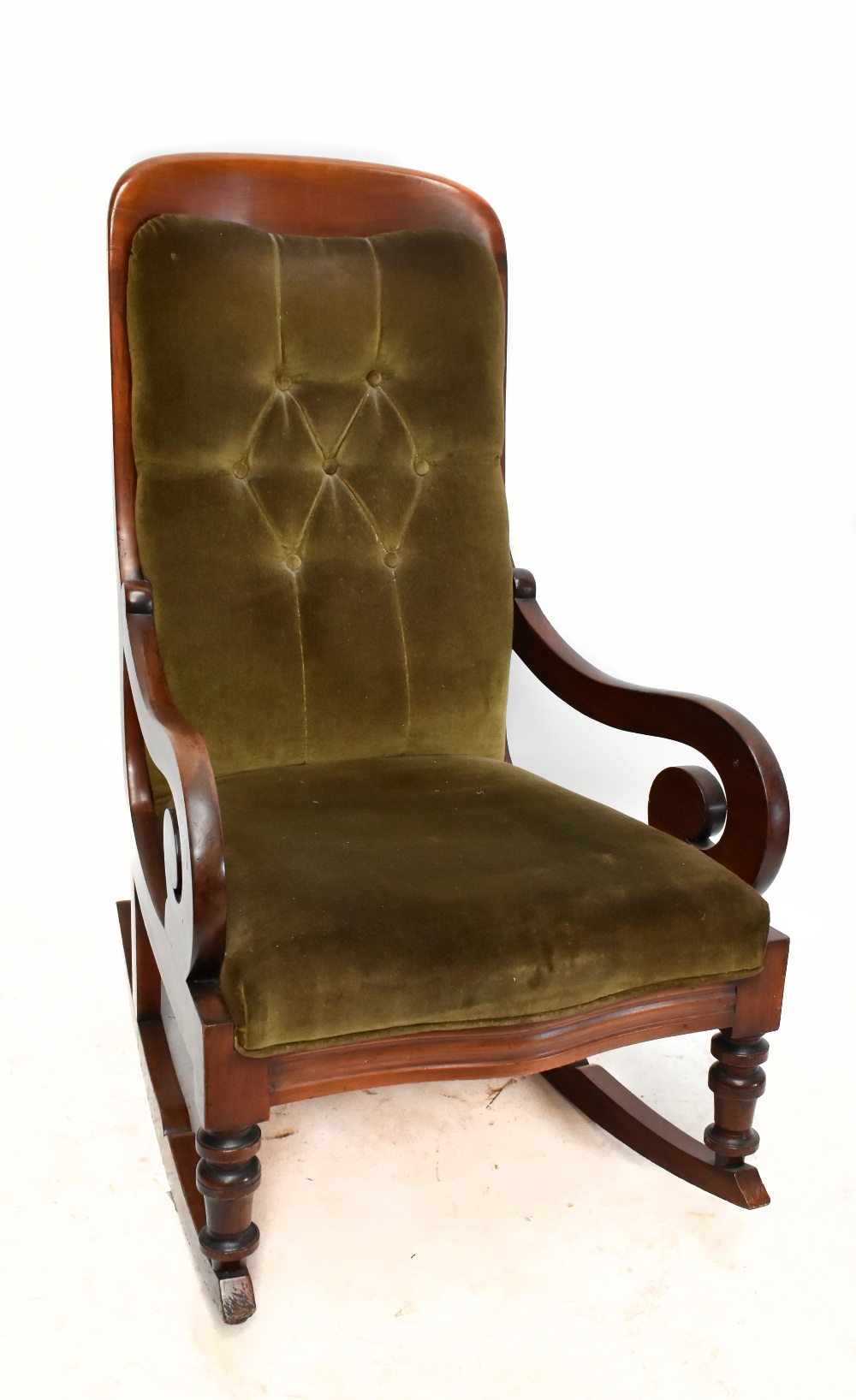 A rocking chair of serpentine outline with scroll arms on turned supports.Additional InformationSome