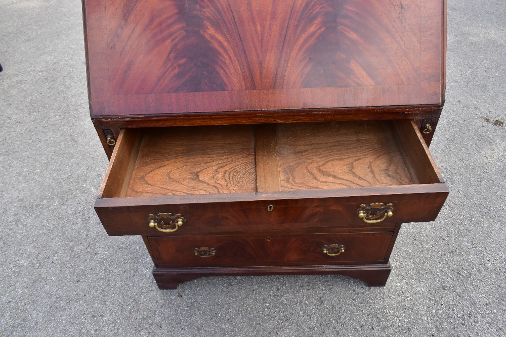 A reproduction mahogany veneered bureau, the fall front above four drawers, raised on bracket - Image 4 of 4