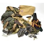 A group of military and military-type equipment including canvas bags, holsters, entrenching tool,