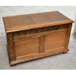 A 1940s carved oak coffer, with double panelled front and stile feet, height  59cm, width 96cm,