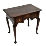 A mid 18th century Provincial oak lowboy, the rectangular top with a moulded edge and pinched