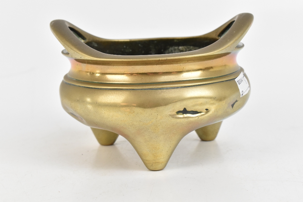 A Chinese bronze censer with pierced twin raised handles and three simple tapering supports, - Image 3 of 7