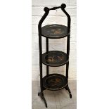 An mid-20th century black lacquered three tier folding cake stand with chinoiserie decoration,