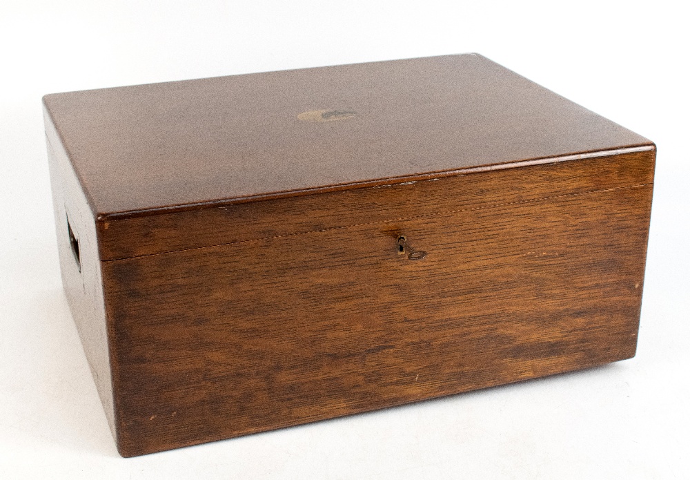 A early 20th century oak cased canteen, the hinged cover enclosing four empty trays, length 49cm.